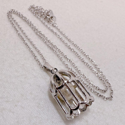 Tasaki Pearl Basket Necklace with bell sound made of 925 silver, shown on white background