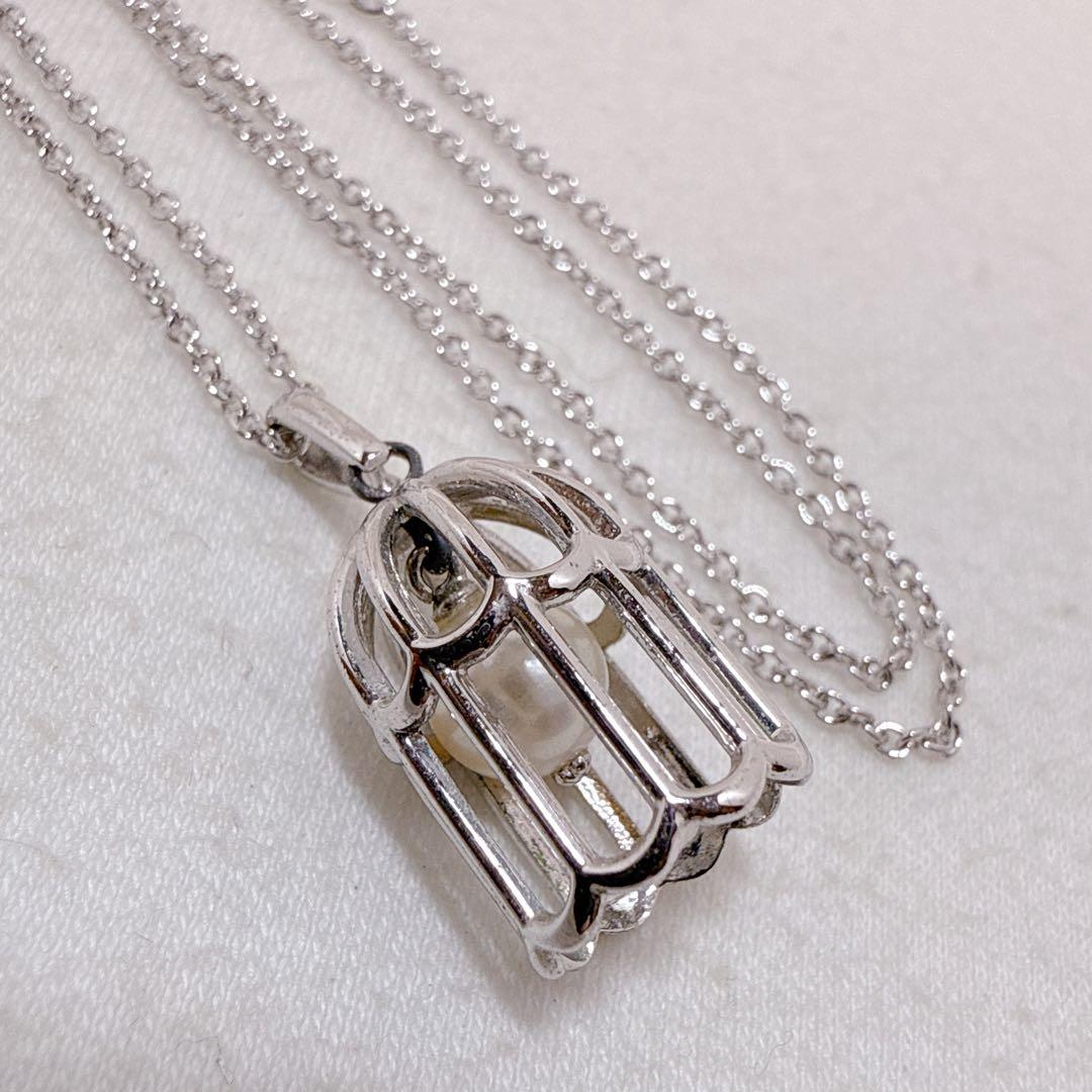Tasaki Pearl Basket Necklace with bell sound made of 925 silver, shown on white background