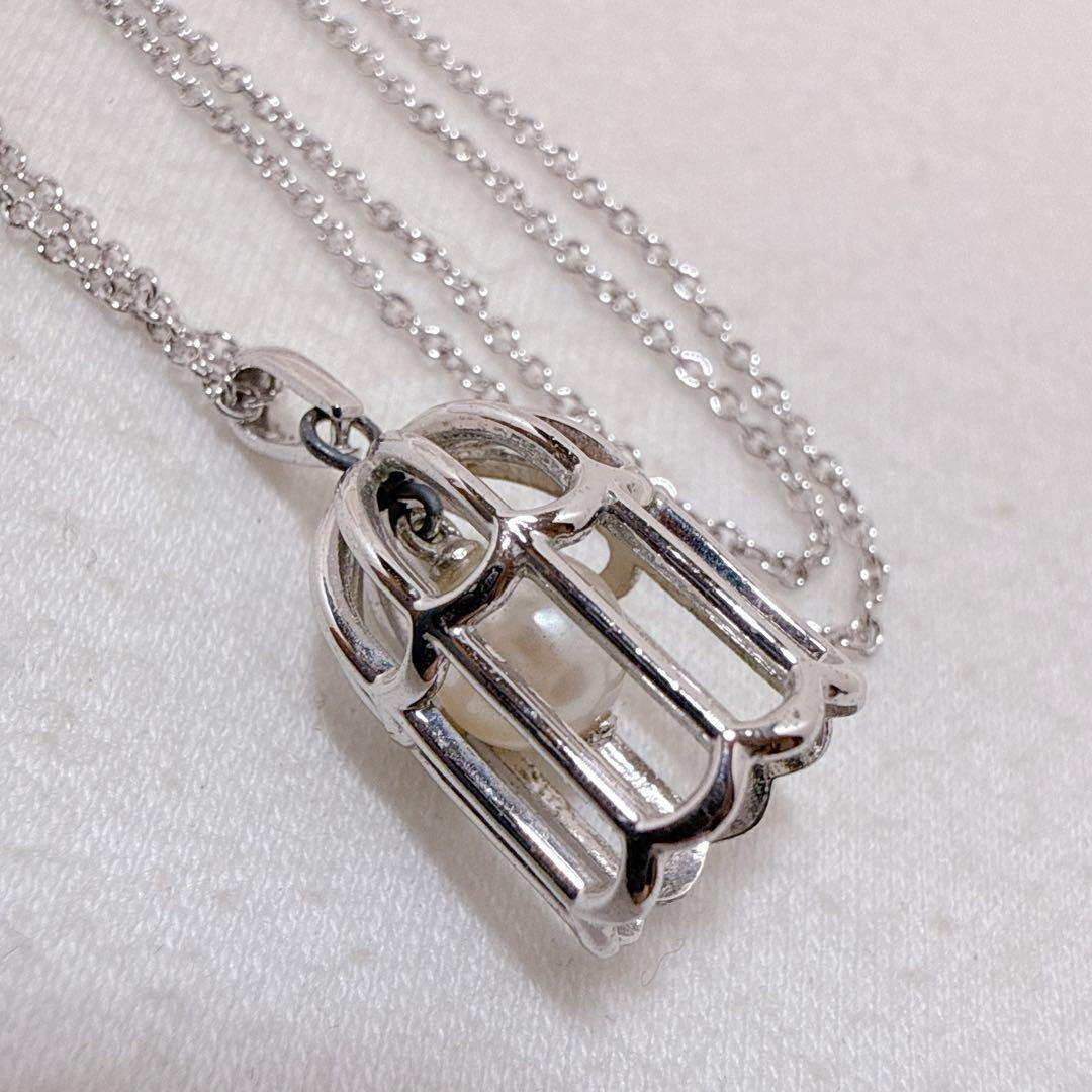Tasaki Pearl Basket Necklace with bell sound made of 925 silver, shown on white background