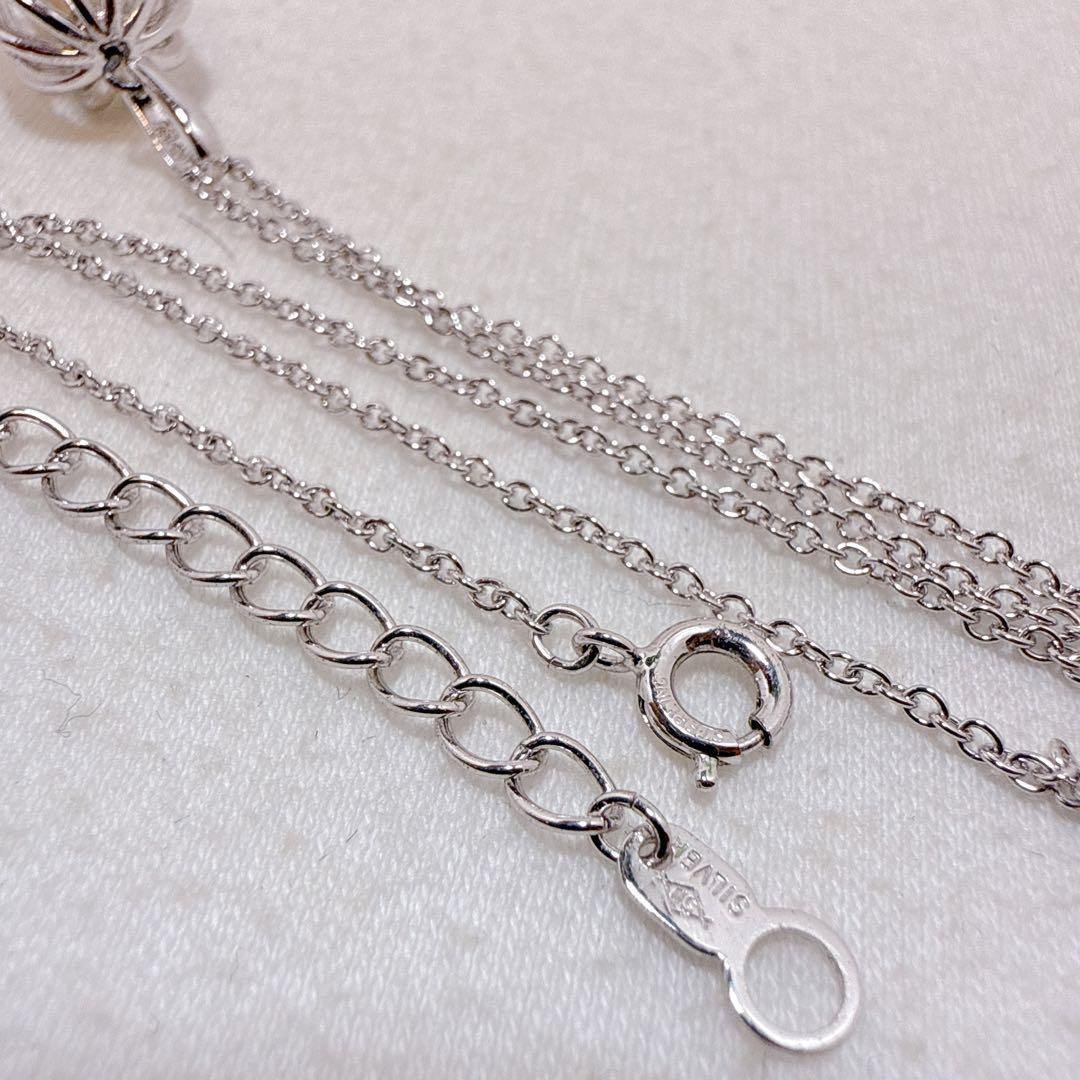 Tasaki Pearl Basket Necklace with bell sound made of 925 silver, shown on white background
