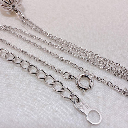 Tasaki Pearl Basket Necklace with bell sound made of 925 silver, shown on white background