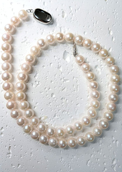 Close-up of an Akoya pearl necklace with 6.5-7mm pearls and a sterling silver clasp on a white background