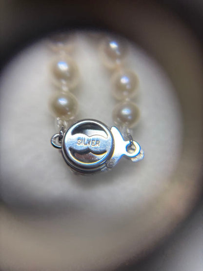 Akoya baby pearl necklace featuring smooth pearls and a silver 925 clasp on a 200mm chain