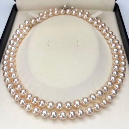 Long double-strand pearl necklace with large Akoya pearls and aurora interference colors in champagne or white gold
