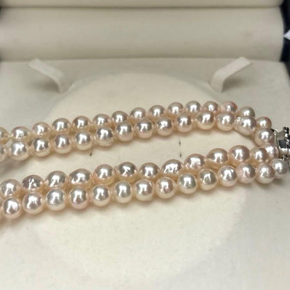 Long double-strand pearl necklace with large Akoya pearls and aurora interference colors in champagne or white gold