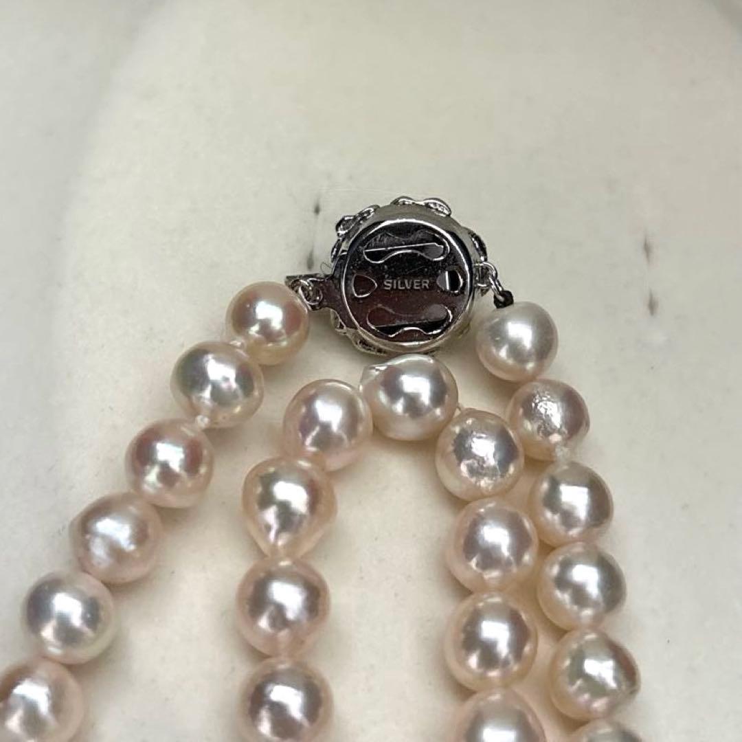 Long double-strand pearl necklace with large Akoya pearls and aurora interference colors in champagne or white gold