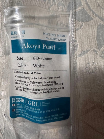 Akoya pearl necklace with 8.0-8.5mm white pearls and silver stamped clasp with certification tag