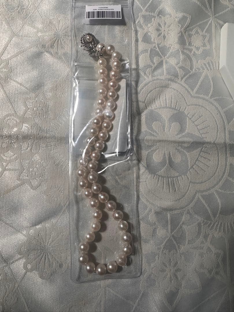 Akoya pearl necklace with 8.0-8.5mm white pearls and silver stamped clasp with certification tag