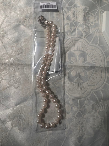 Akoya pearl necklace with 8.0-8.5mm white pearls and silver stamped clasp with certification tag