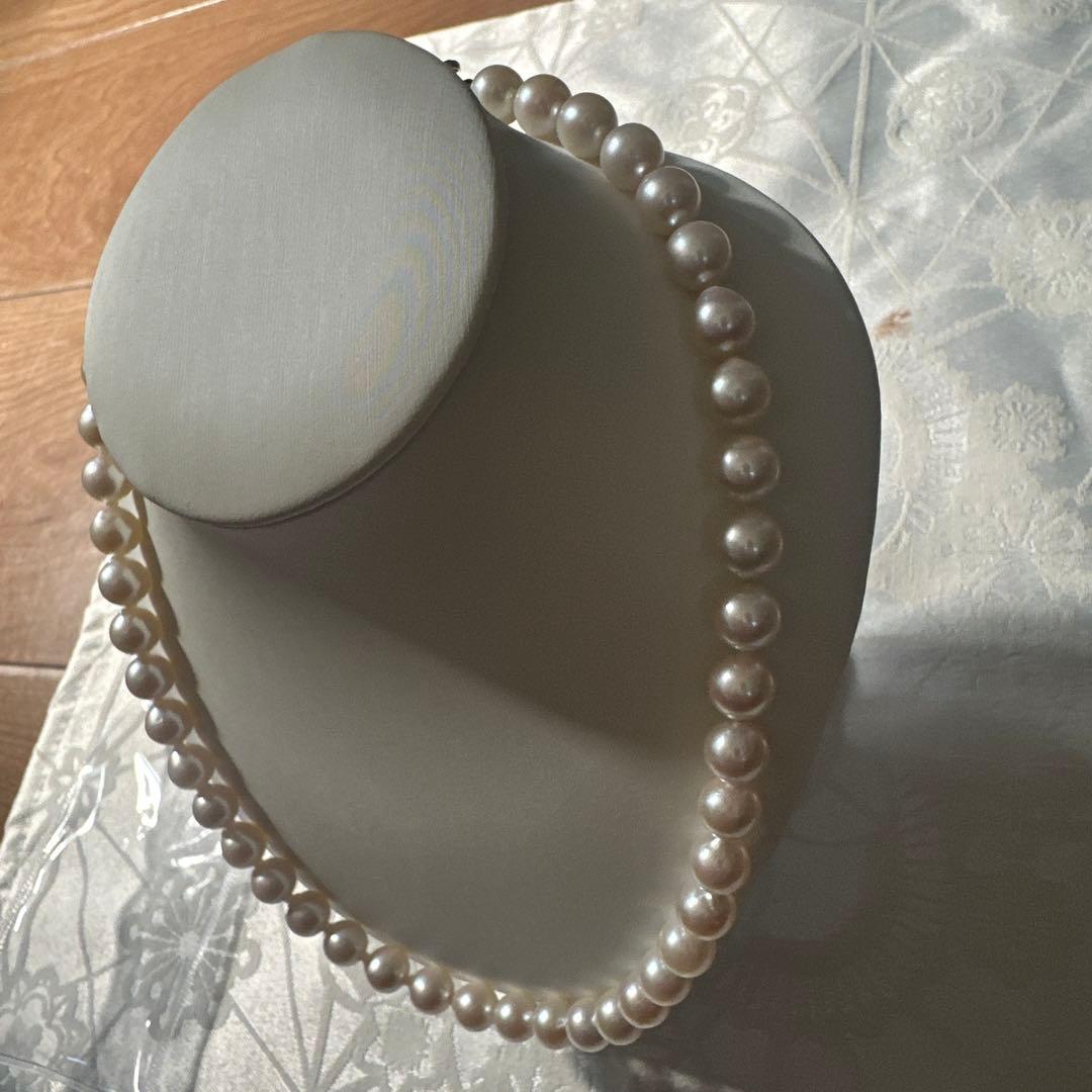 Akoya pearl necklace with 8.0-8.5mm white pearls and silver stamped clasp with certification tag