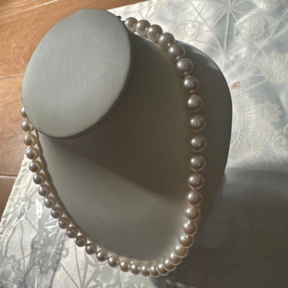 Akoya pearl necklace with 8.0-8.5mm white pearls and silver stamped clasp with certification tag