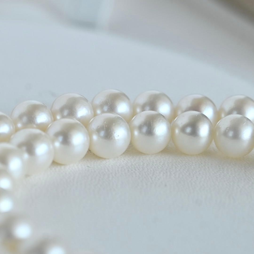 Takaski pearl necklace featuring 6.5mm Akoya round pearls and silver clasp on a white background