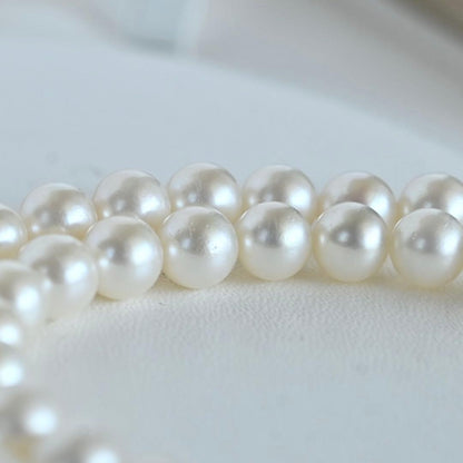 Takaski pearl necklace featuring 6.5mm Akoya round pearls and silver clasp on a white background