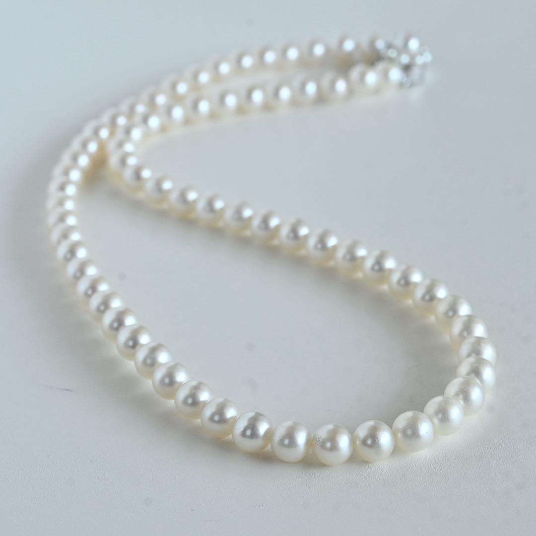Takaski pearl necklace featuring 6.5mm Akoya round pearls and silver clasp on a white background