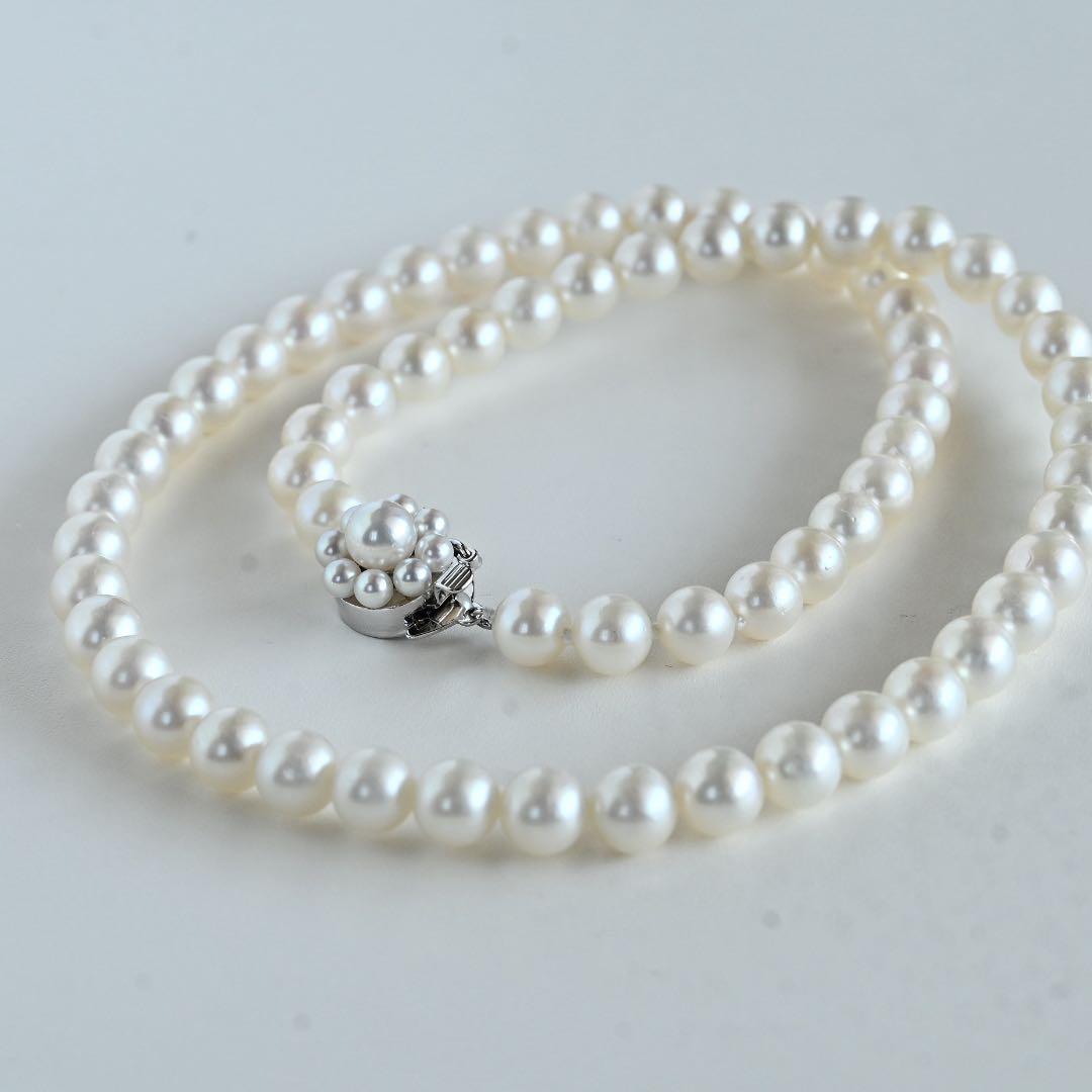 Takaski pearl necklace featuring 6.5mm Akoya round pearls and silver clasp on a white background