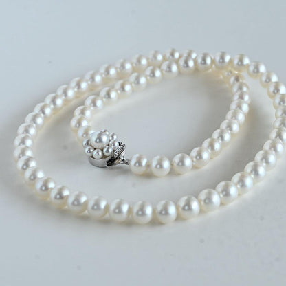 Takaski pearl necklace featuring 6.5mm Akoya round pearls and silver clasp on a white background
