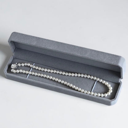 Takaski pearl necklace featuring 6.5mm Akoya round pearls and silver clasp on a white background