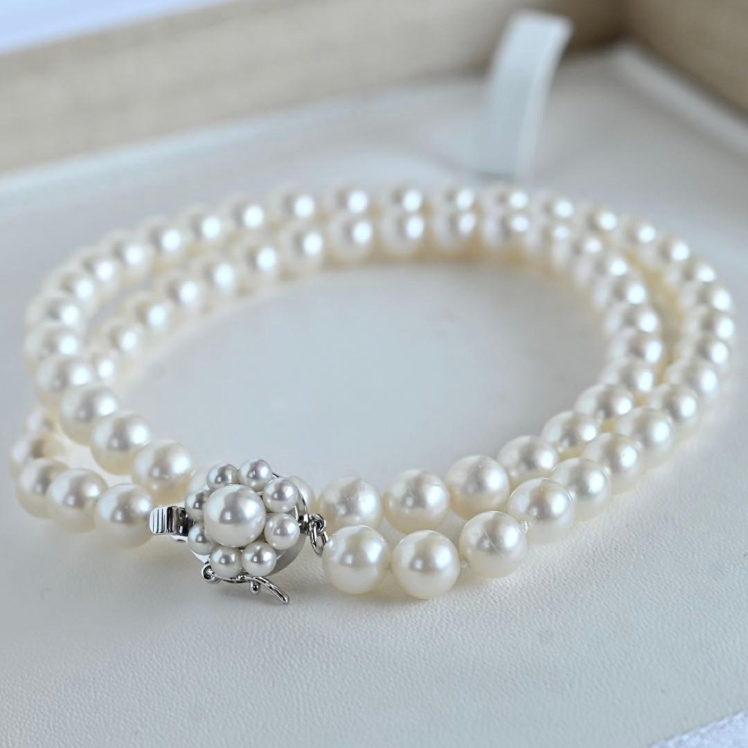 Takaski pearl necklace featuring 6.5mm Akoya round pearls and silver clasp on a white background