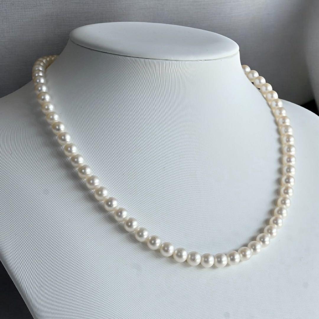 Takaski pearl necklace featuring 6.5mm Akoya round pearls and silver clasp on a white background