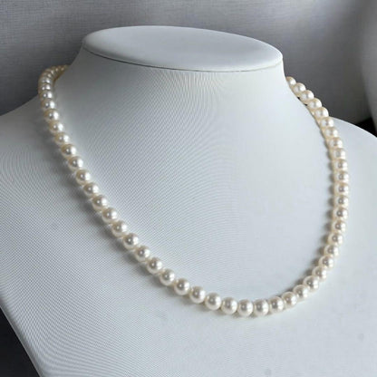 Takaski pearl necklace featuring 6.5mm Akoya round pearls and silver clasp on a white background