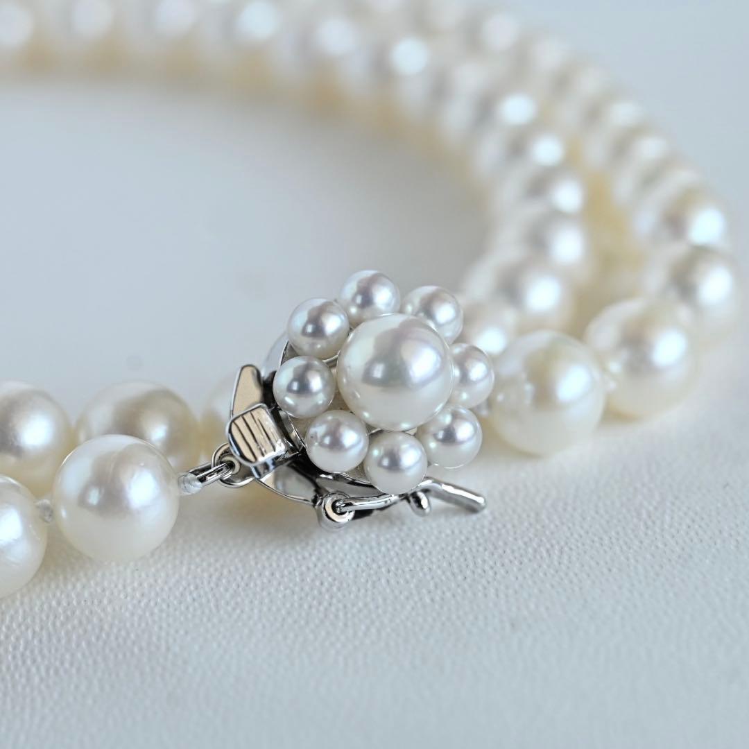 Takaski pearl necklace featuring 6.5mm Akoya round pearls and silver clasp on a white background