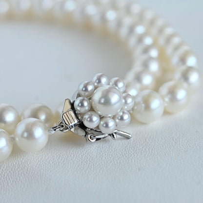 Takaski pearl necklace featuring 6.5mm Akoya round pearls and silver clasp on a white background