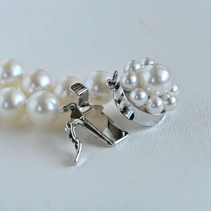 Takaski pearl necklace featuring 6.5mm Akoya round pearls and silver clasp on a white background