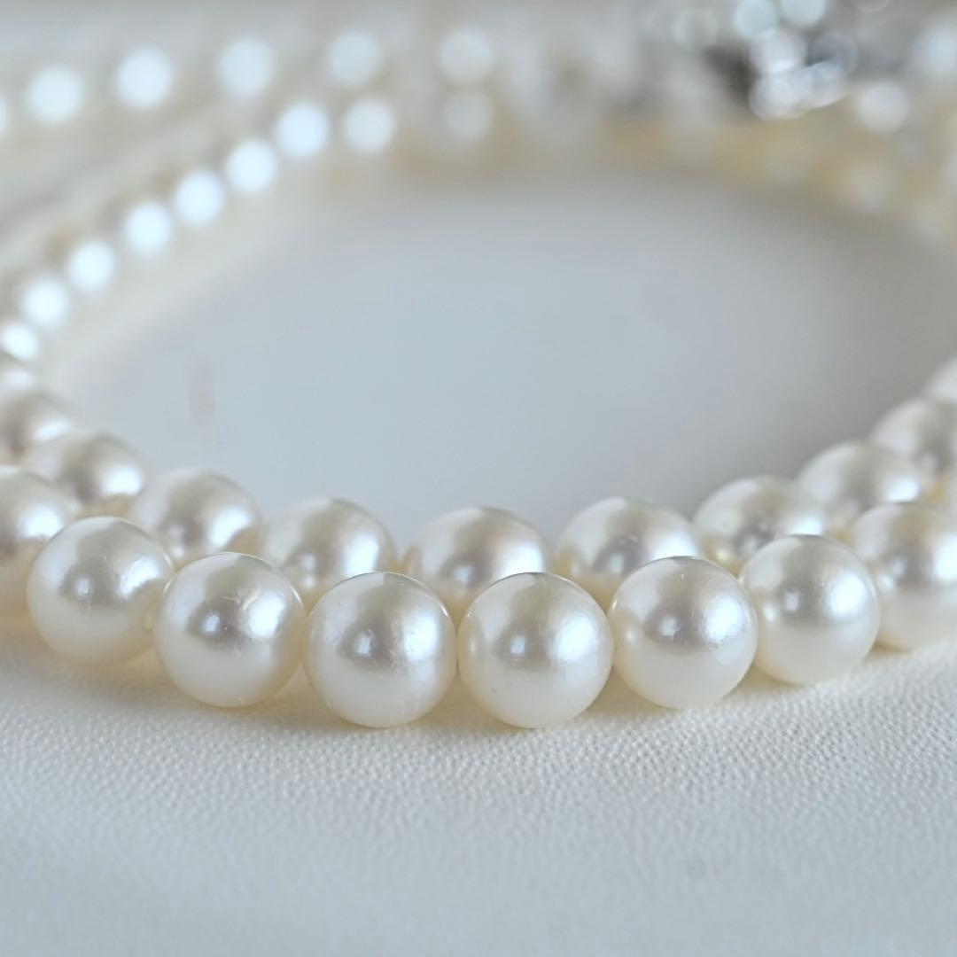 Takaski pearl necklace featuring 6.5mm Akoya round pearls and silver clasp on a white background