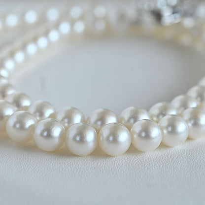Takaski pearl necklace featuring 6.5mm Akoya round pearls and silver clasp on a white background