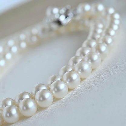 Takaski pearl necklace featuring 6.5mm Akoya round pearls and silver clasp on a white background
