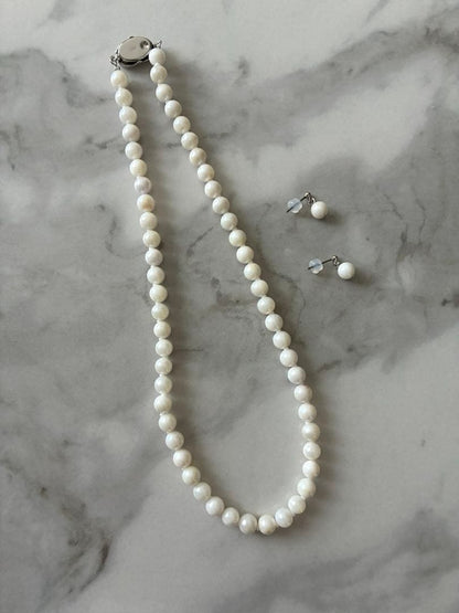 6.5mm Akoya pearl necklace approximately 42cm with matching earrings 13x6.5mm featuring natural pearl markings