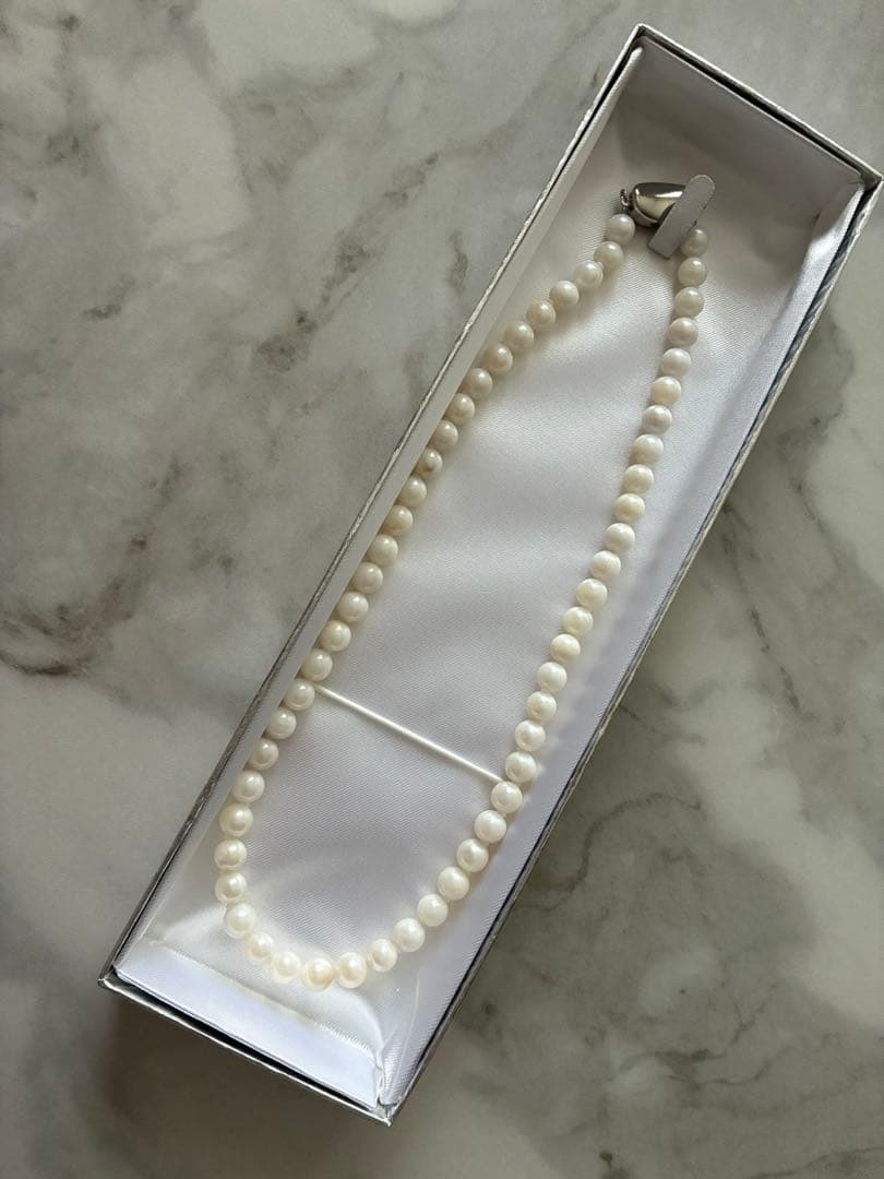 6.5mm Akoya pearl necklace approximately 42cm with matching earrings 13x6.5mm featuring natural pearl markings