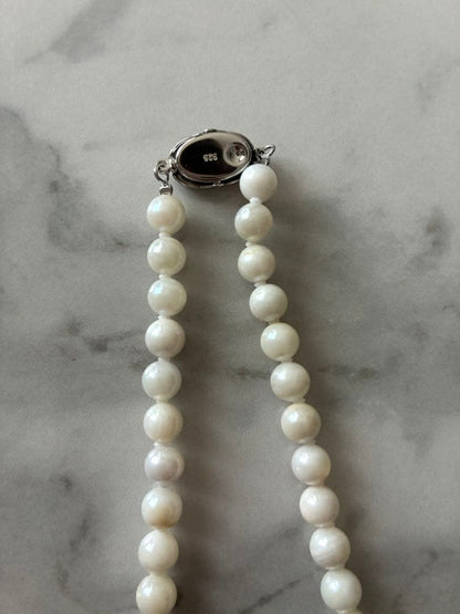 6.5mm Akoya pearl necklace approximately 42cm with matching earrings 13x6.5mm featuring natural pearl markings