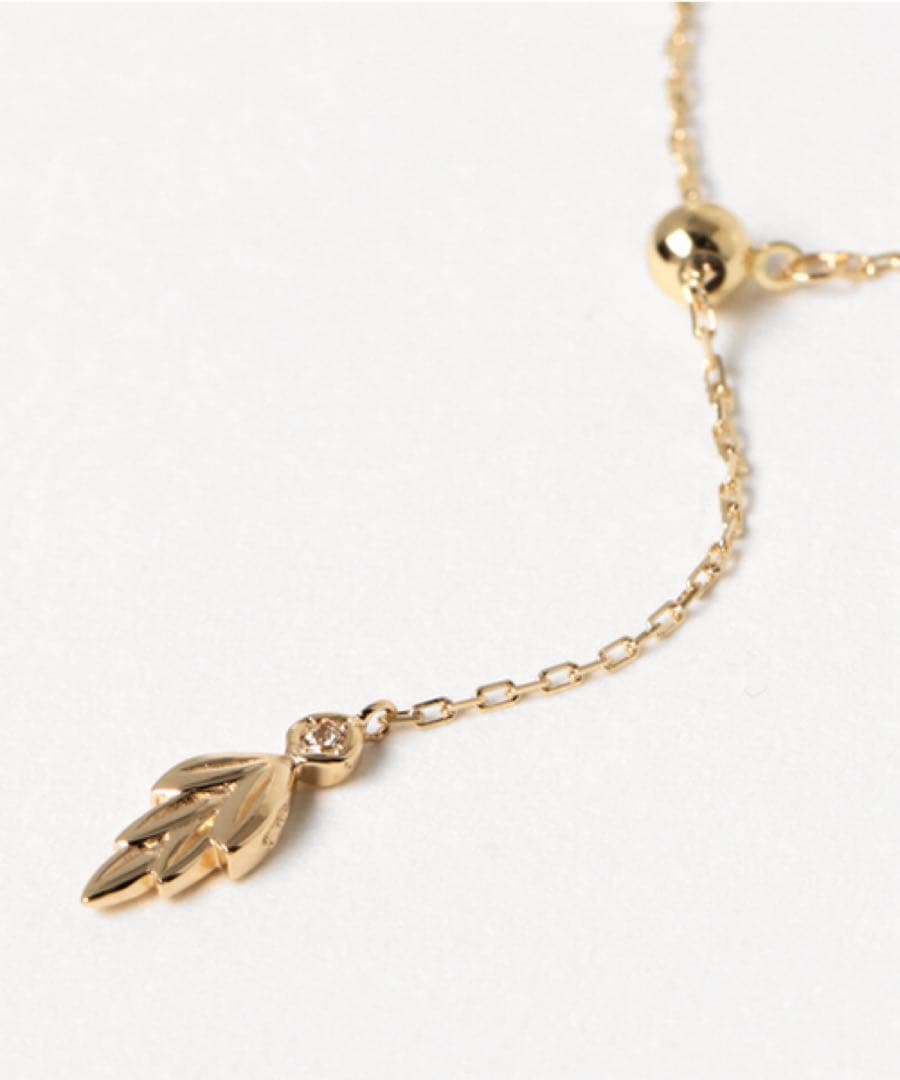 agete K10 gold Y-shaped necklace with a single diamond leaf pendant and sliding ball chain