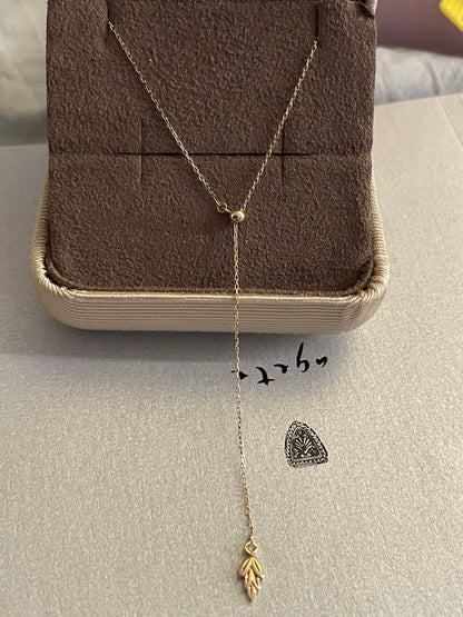 agete K10 gold Y-shaped necklace with a single diamond leaf pendant and sliding ball chain