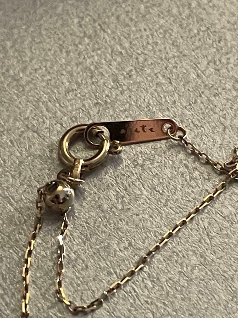 agete K10 gold Y-shaped necklace with a single diamond leaf pendant and sliding ball chain