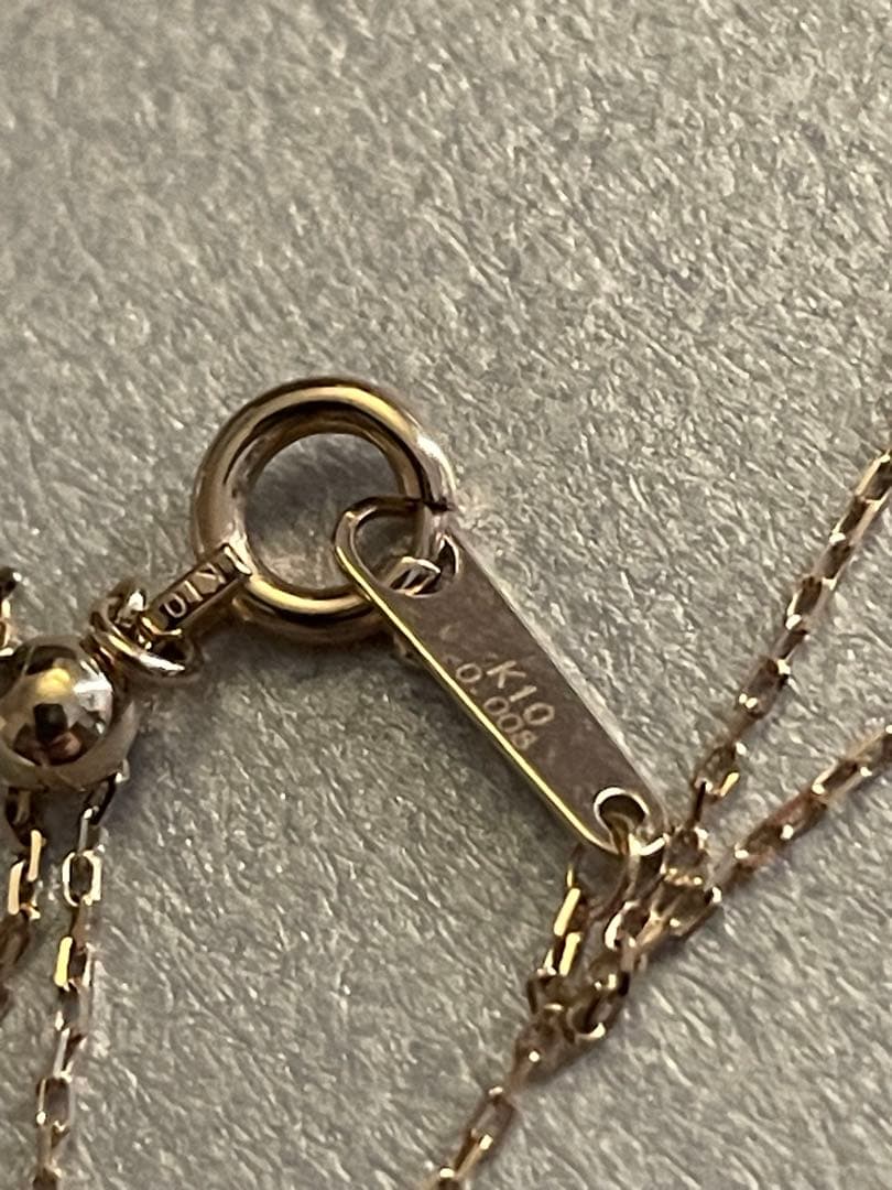 agete K10 gold Y-shaped necklace with a single diamond leaf pendant and sliding ball chain