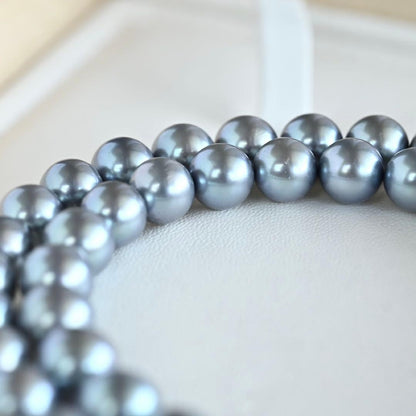 Swanklassup Tasaki Akoya natural blue pearl necklace with 7.5mm pearls displayed on white background