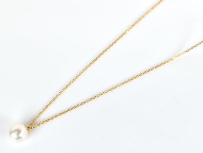 Mikimoto necklace with single 7mm Akoya pearl on 18K yellow gold chain, 40cm length, Mikimoto engraving visible