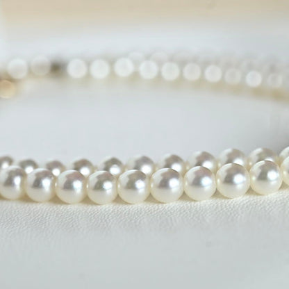 Mikimoto Akoya pearl necklace with round baby pearls on 18-karat yellow gold chain, 36cm length