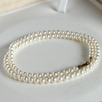 Mikimoto Akoya pearl necklace with round baby pearls on 18-karat yellow gold chain, 36cm length
