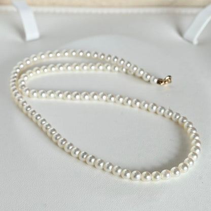 Mikimoto Akoya pearl necklace with round baby pearls on 18-karat yellow gold chain, 36cm length