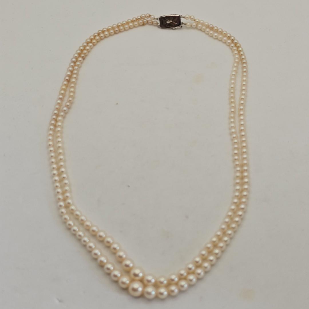 Akoya pearl two-strand gradient necklace with silver clasp, 43cm length displayed on white background
