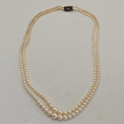 Akoya pearl two-strand gradient necklace with silver clasp, 43cm length displayed on white background