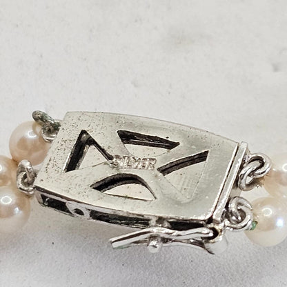 Akoya pearl two-strand gradient necklace with silver clasp, 43cm length displayed on white background