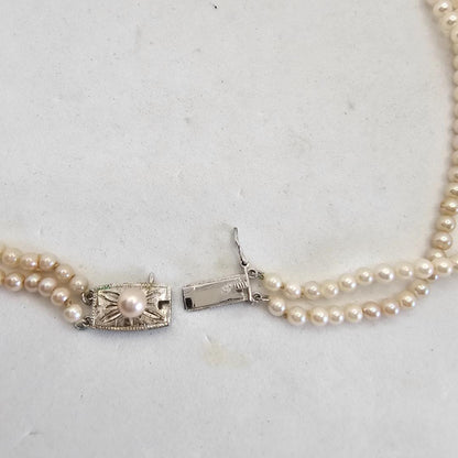 Akoya pearl two-strand gradient necklace with silver clasp, 43cm length displayed on white background