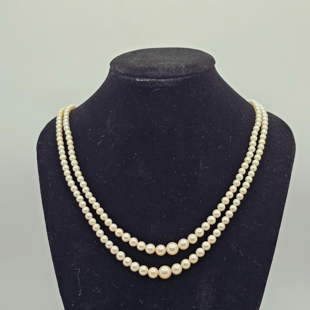 Akoya pearl two-strand gradient necklace with silver clasp, 43cm length displayed on white background