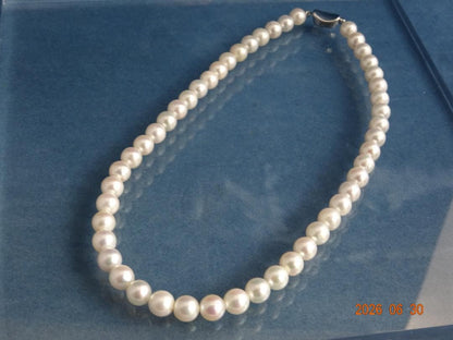 Akoya pearl necklace with 8-8.5mm white semi-round pearls showing subtle pink and cream tones