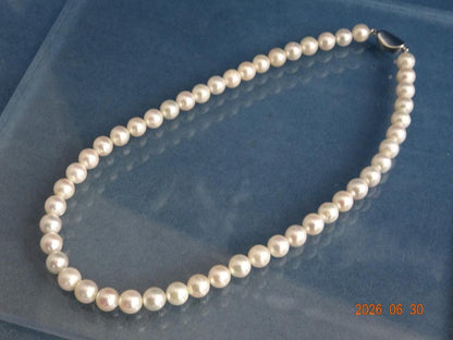 Akoya pearl necklace with 8-8.5mm white semi-round pearls showing subtle pink and cream tones