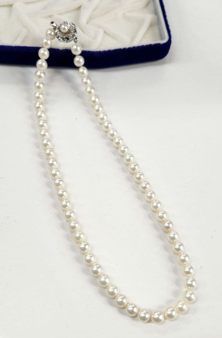 Akoya Pearl Necklace featuring 7 mm white pearl beads, 42 cm length, laid out on a white background